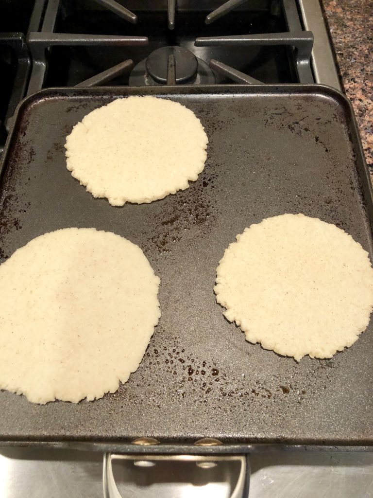 Corn tortillas being made on the skillet