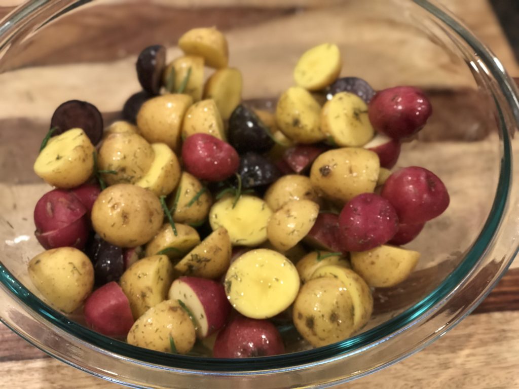 Potatoes mixed with oil, lemon & herbs