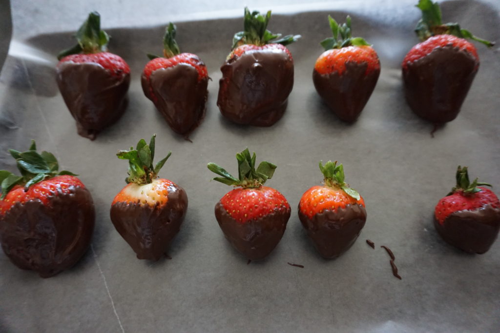 Chocolate Covered Strawberries Hardening on Parchment Paper.