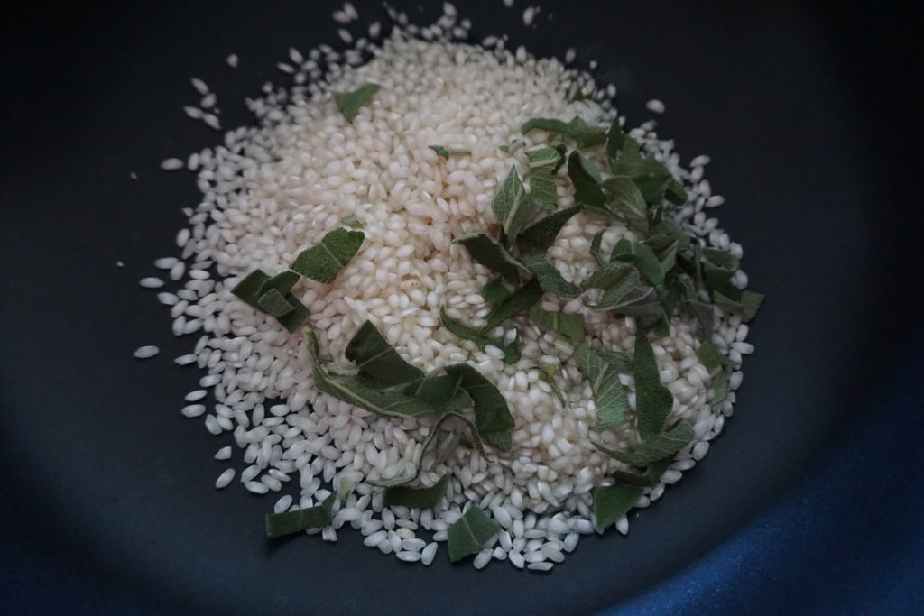 Rice, Green Onion, and Sage Sautéed in Saucepan. 