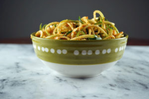 Zoodles in pasta sauce in a bowl on the counter