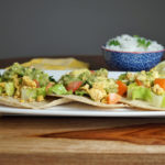 FODMAP safe dinner - Ground Turkey Tacos on a white plate with a bowl of rice