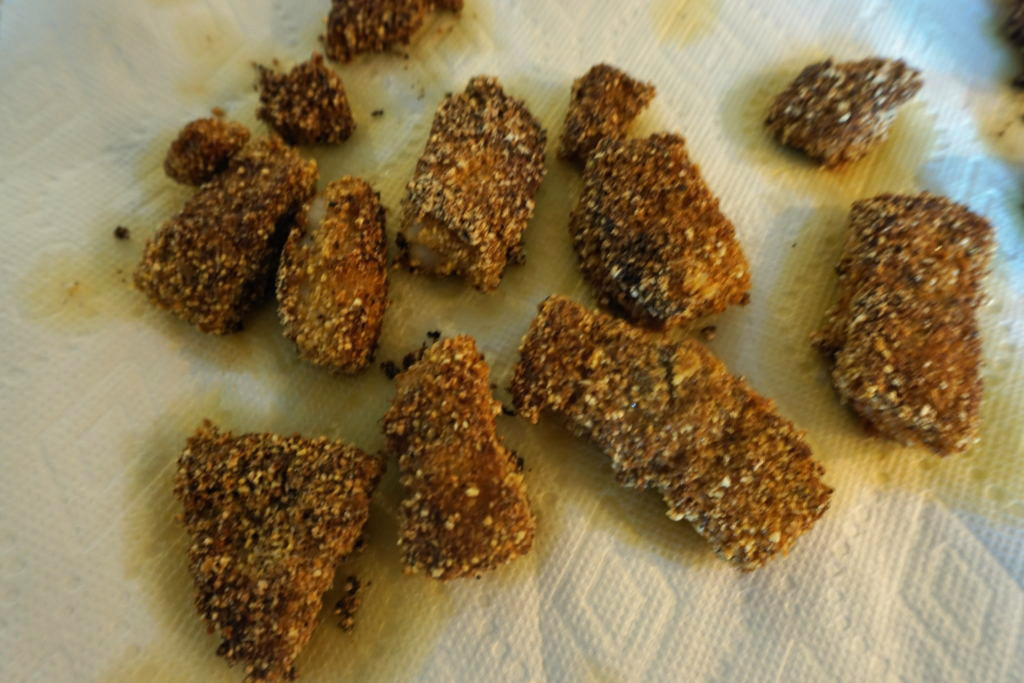 FODMAP safe fish crusted in cornmeal - fish laying on paper towels to take out excess oil.