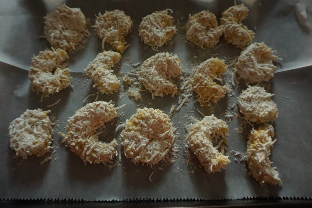 fodmap shrimp coated on a baking sheet ready to be cooked in the oven.