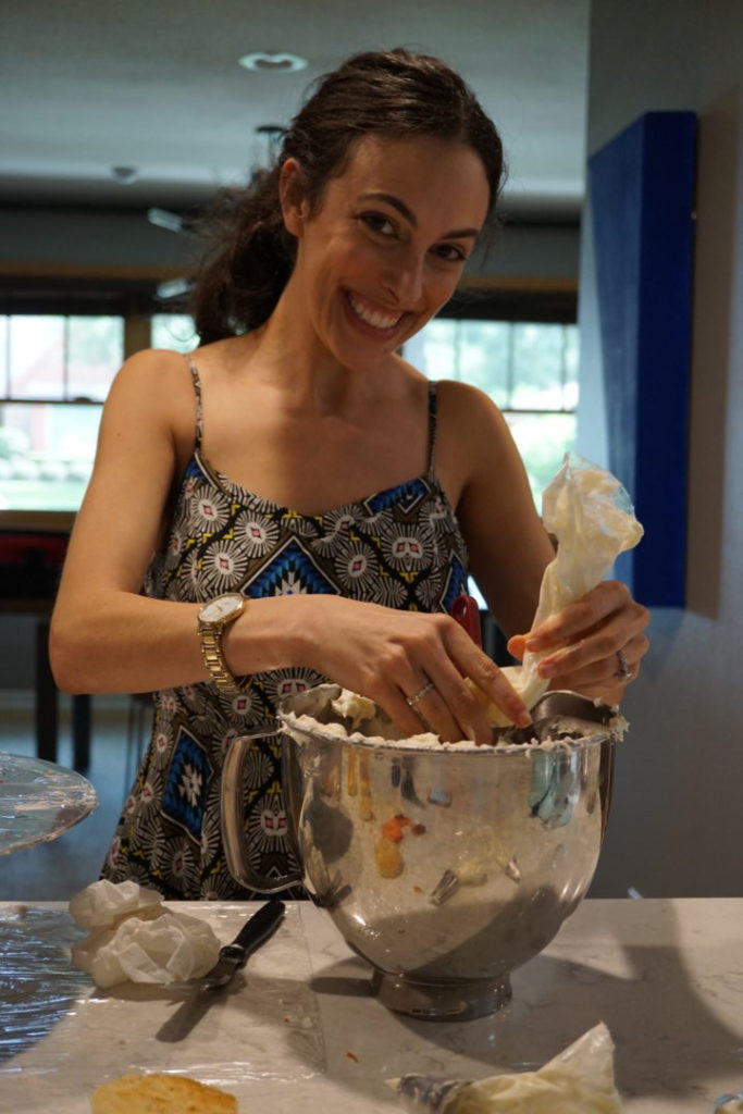 Trying to not make a mess while I refill my frosting bag.