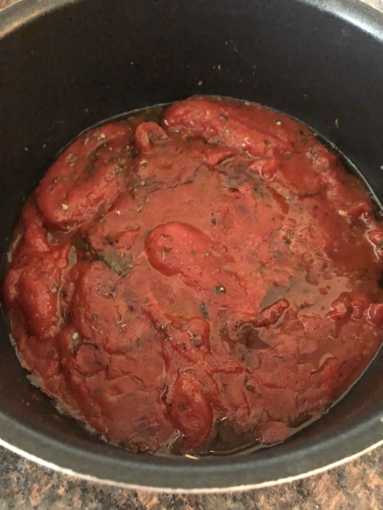 Low FODMAP tomato sauce simmering.