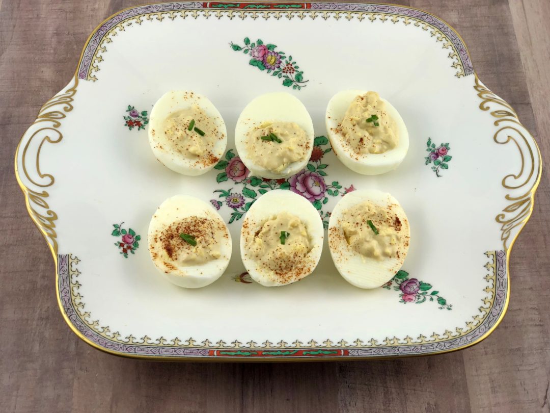 6 deviled eggs on a vintage plate