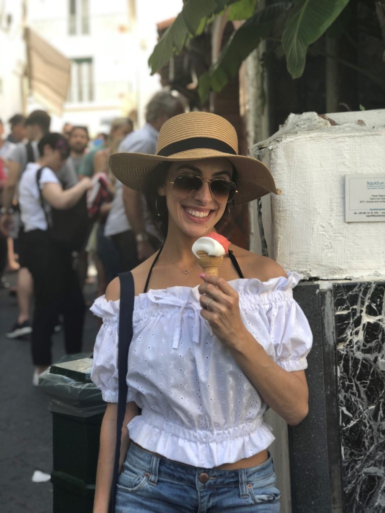 I'm eating lemon and strawberry gelato in a gluten-free cone in Capri.