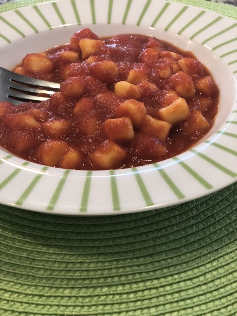 We made homemade gnocchi - final product in a white and green bowl.