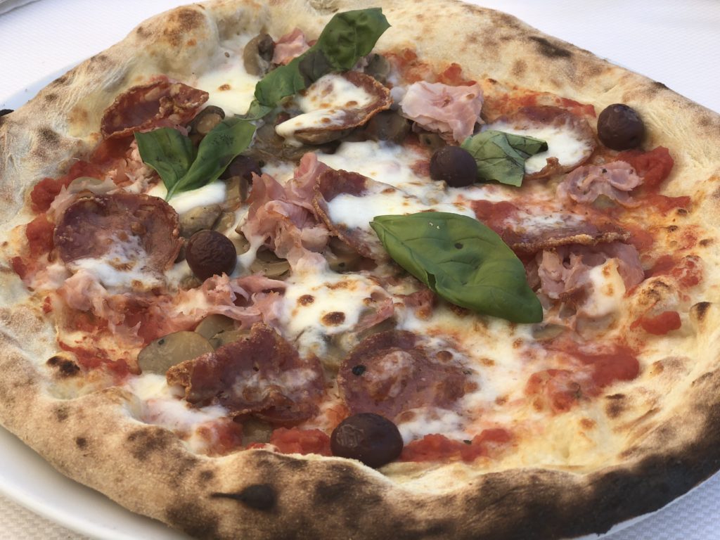 Pizza on a white plate for lunch in Capri, Italy.