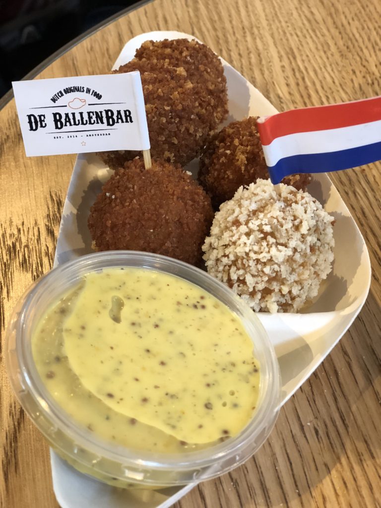 Enjoying lunch at the Foodhallen in Amsterdam - bitterbal - traditional Dutch food.