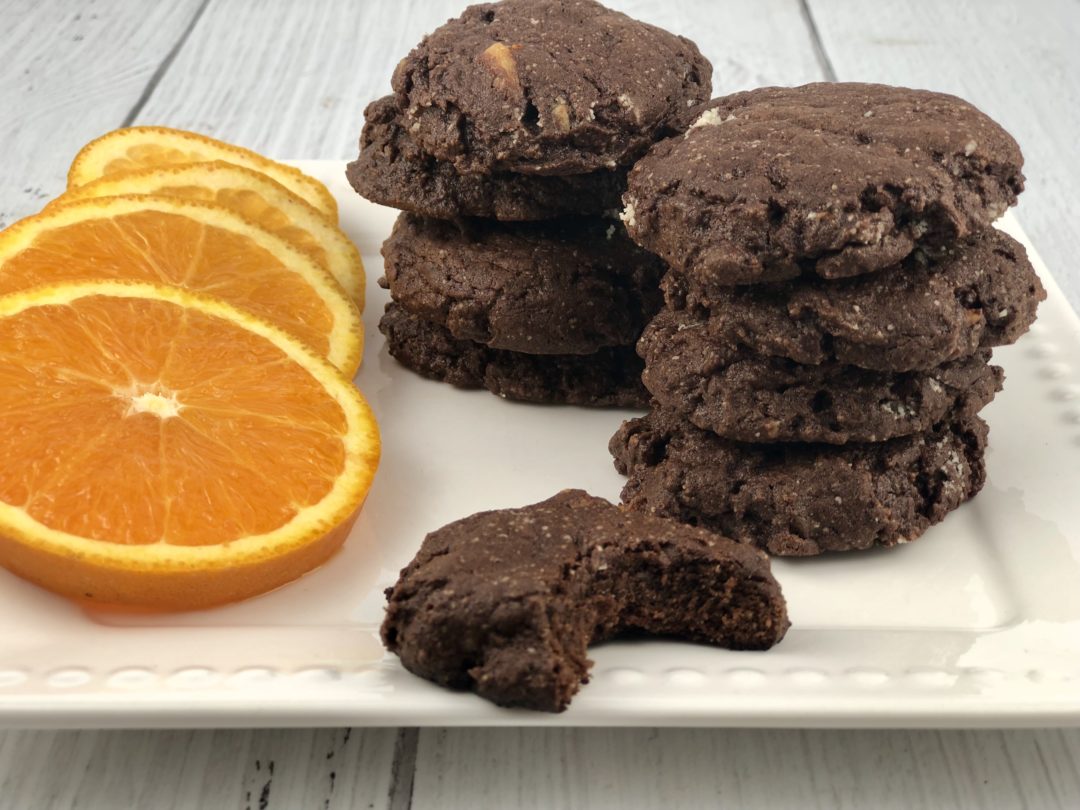 FODMAP cookies - Chocolate brownie cookies with candied oranges on a white plate