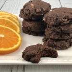 FODMAP cookies - Chocolate brownie cookies with candied oranges on a white plate