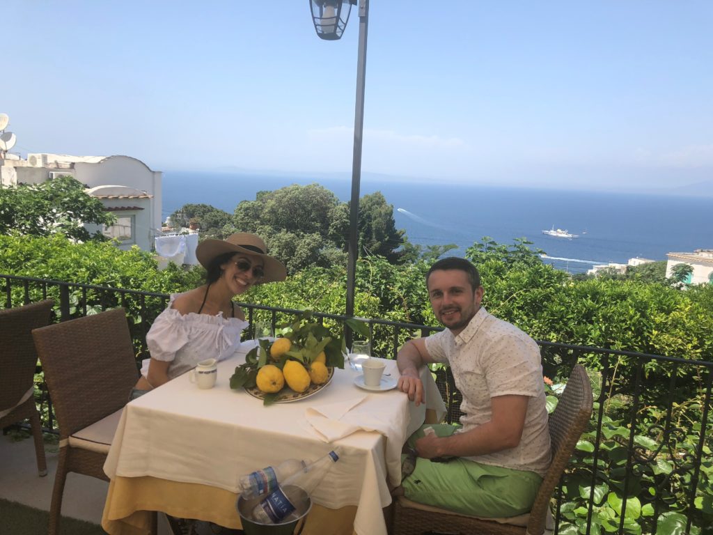 Eugene and I sitting outside to eat lunch in Capri, Italy.