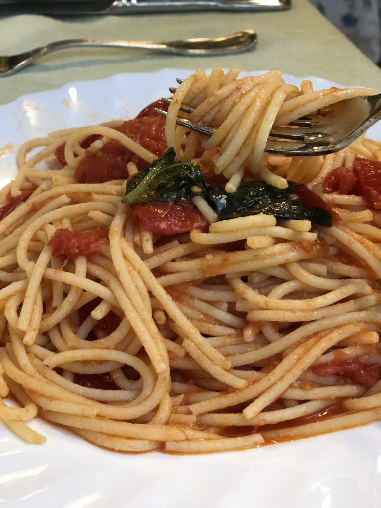 A big bowl of gluten-free pasta with tomatoes and basil at a restaurant in Sorrento, Italy.