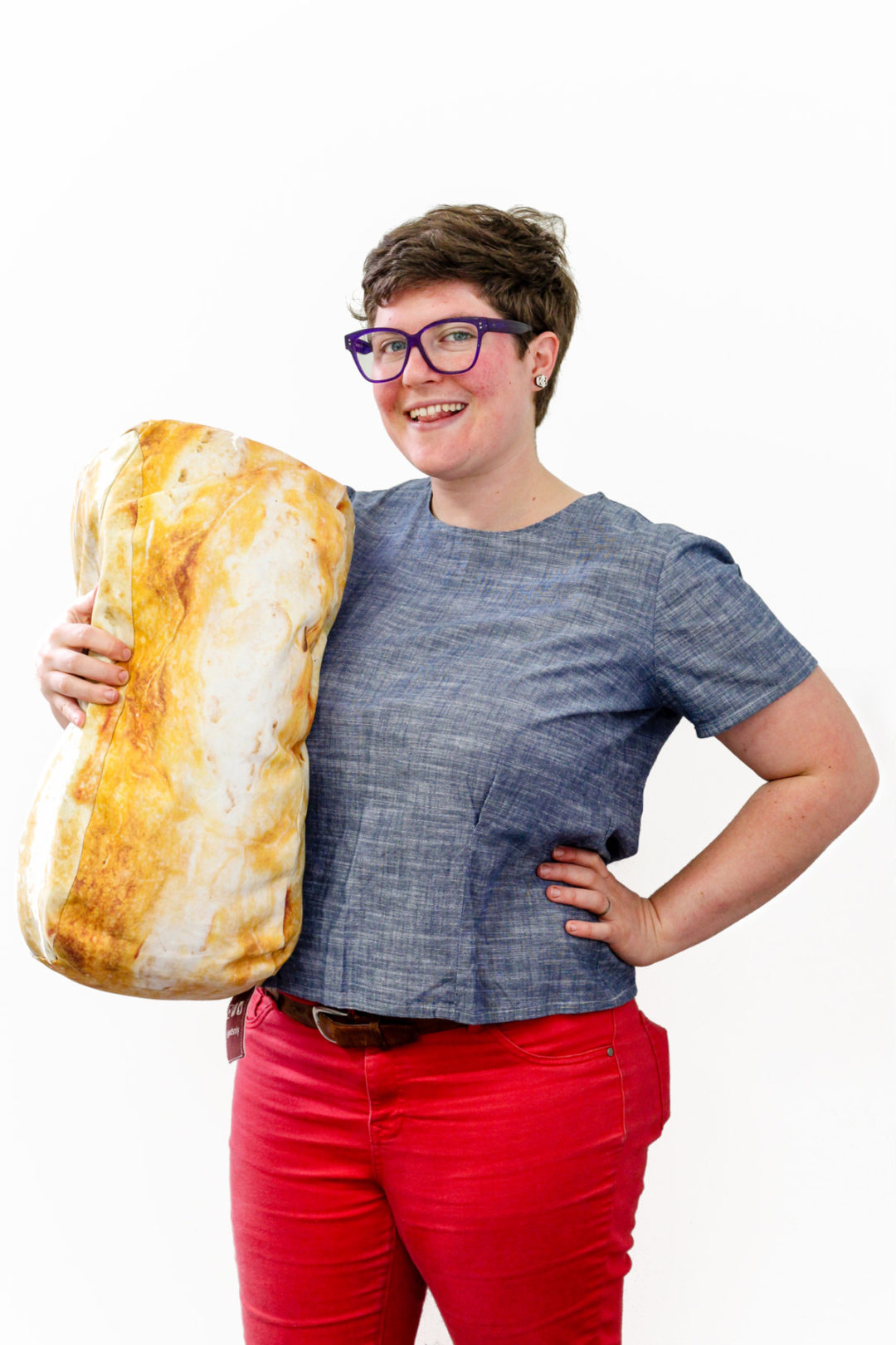 Picture of Sadie holding a large piece of sourdough bread from Bread Srsly