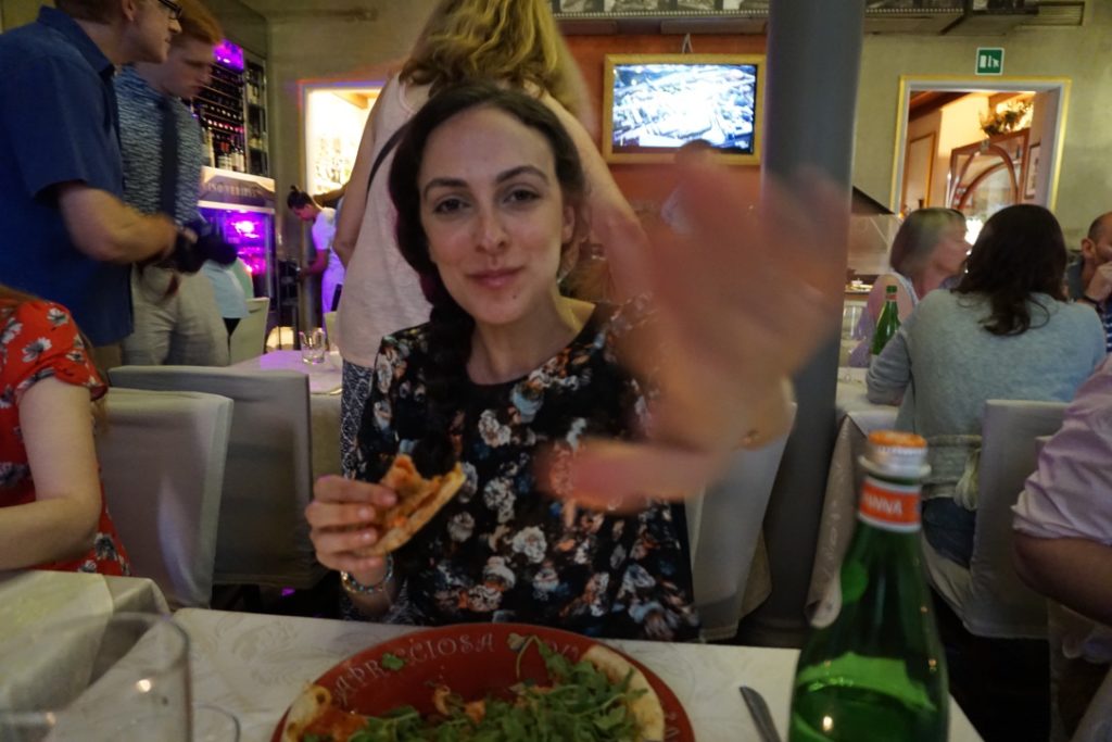 I'm eating pizza in Italy with my hand telling my husband to let me be!  The opposite of mindful eating!