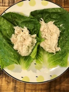 Chicken salad on a bed of lettuce as a FODMAP safe lunch idea.