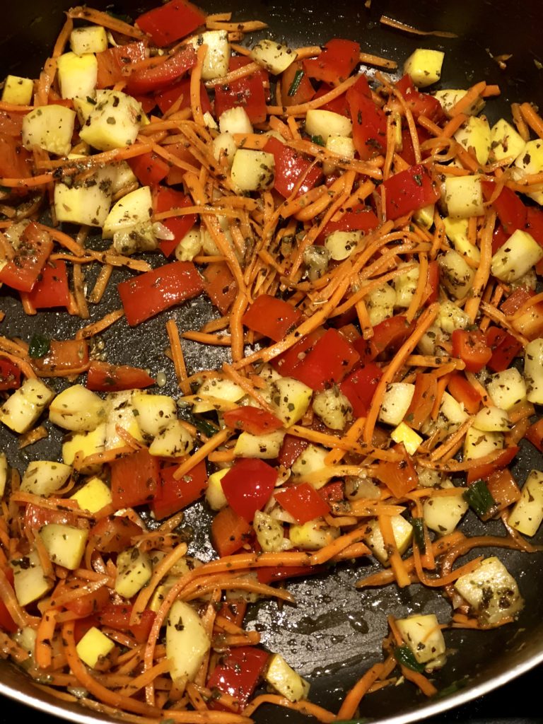 FODMAP safe vegetables being sauteed with herbs in the stove top. 