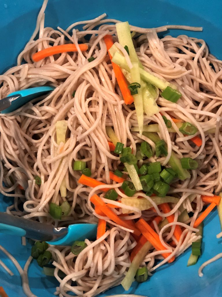 Soba Noodle Salad Ingredients Being Mixed Together.