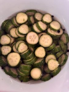 Cucumbers soaking in vinegar mixture