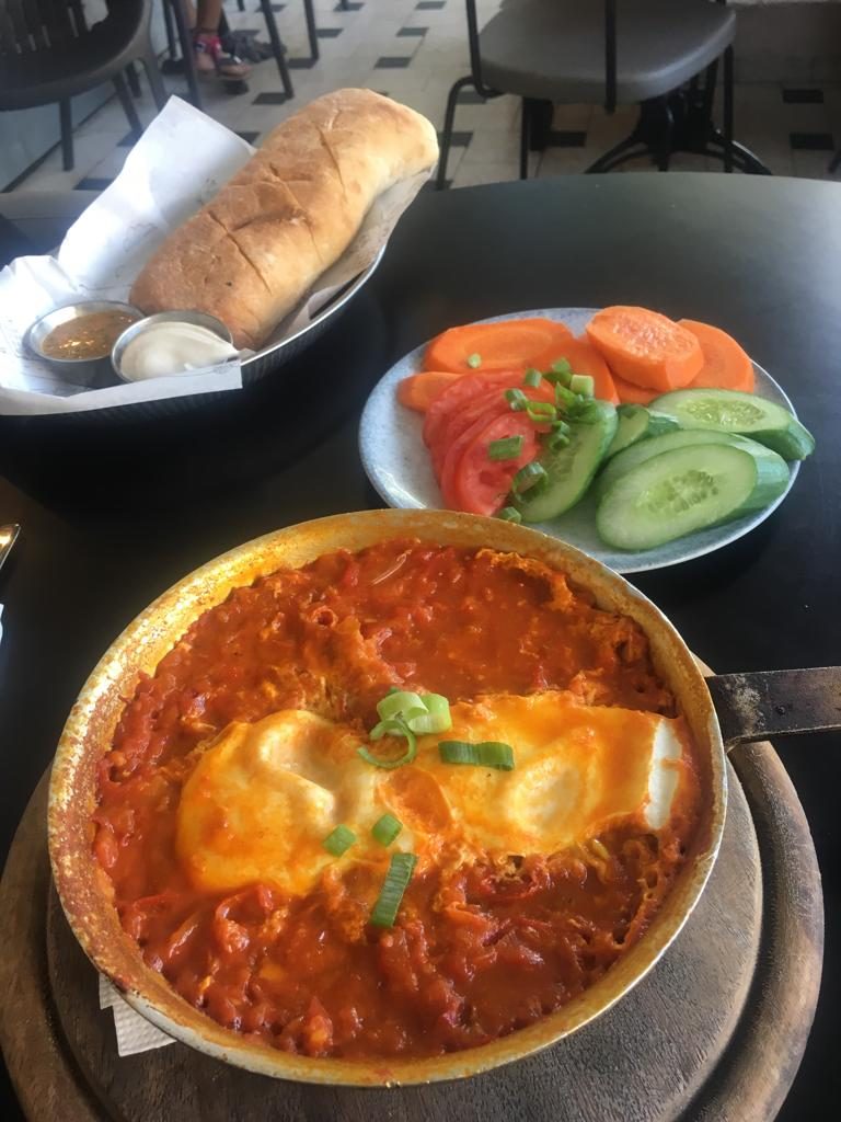 shakshuka eggs being served for breakfast - photo credit D. Wagner